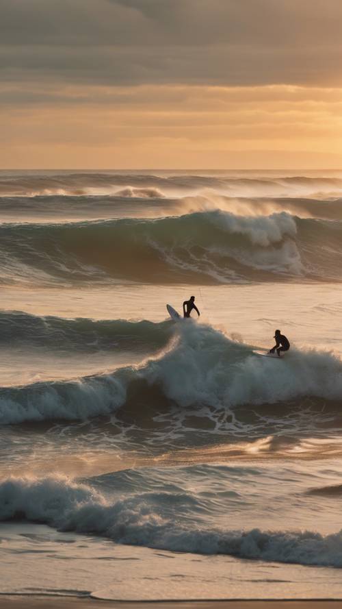 An active beach scene with surfers riding on high ocean waves against the sunset sky.