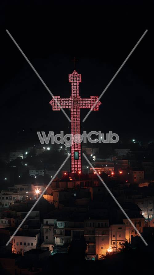 Croix lumineuse sur la ville la nuit