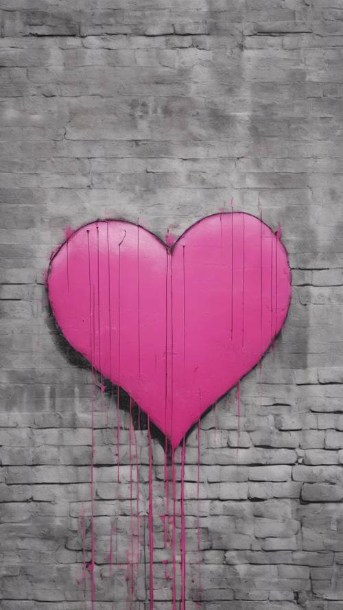 A minimalist pink heart graffiti spray painted on a city wall.