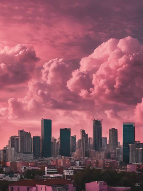 一幅城市天际线的背景是绚丽的粉红色云彩覆盖的天空。