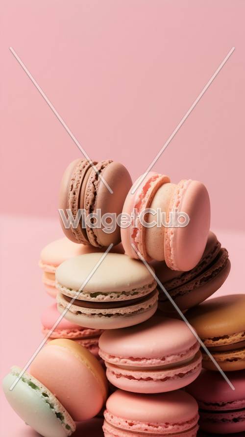 Macarons coloridos sobre un fondo rosa