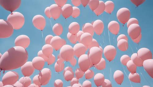 Bunch of baby pink balloons floating in the blue sky.