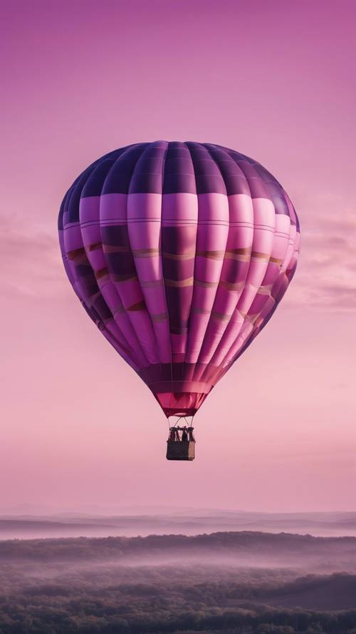 A pink and purple striped hot air balloon floating in a clear morning sky.