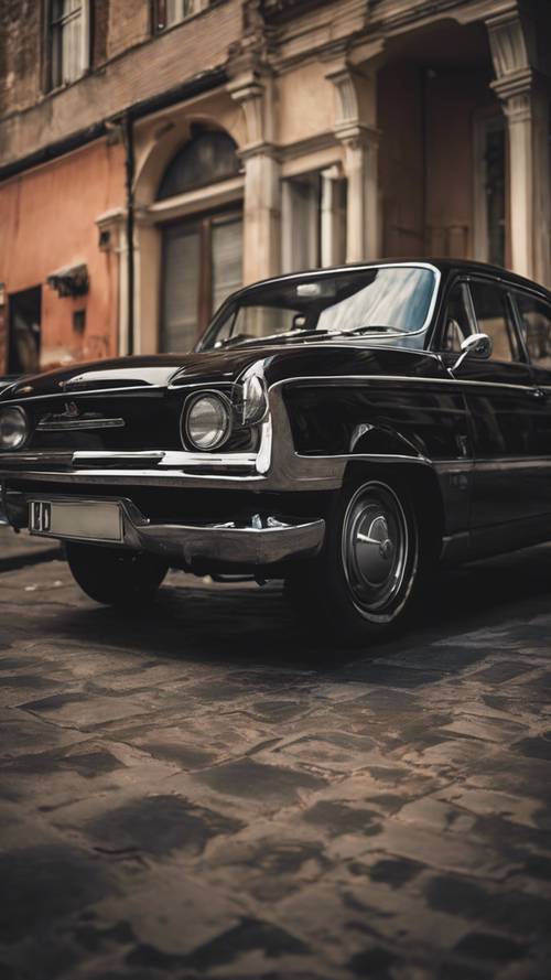 A striking, dark black vintage car against a retro-themed backdrop.