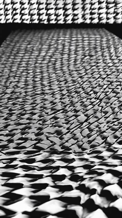 A houndstooth pattern in black and white lying on a tabletop.