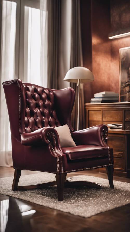 A warm burgundy leather wing-back chair in a cozy reading corner.