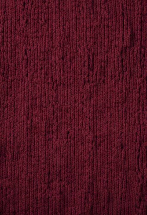 Gestrickte burgunderfarbene Wolle mit unvollkommenem Handarbeitsgefühl, das ein nahtloses Muster ergibt.