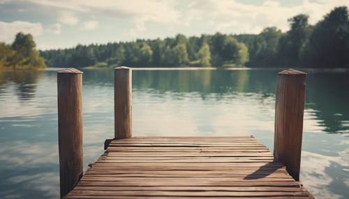 An inviting scene of a wooden dock extending into a calm lake, perfect for a relaxing summer day swim.