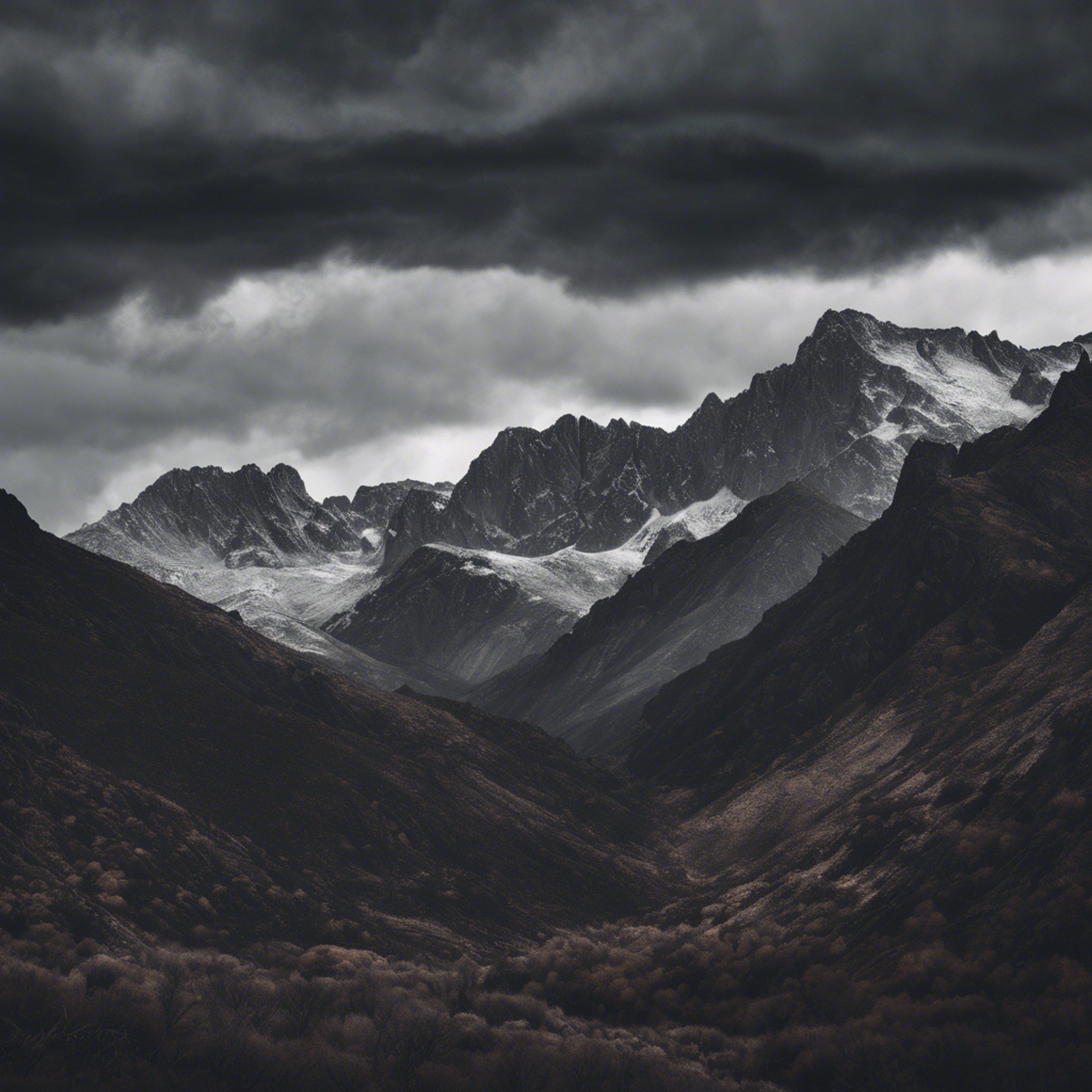 A rugged black and gray mountain range under a stormy skies. Wallpaper[bbf48e9891544a6fb579]