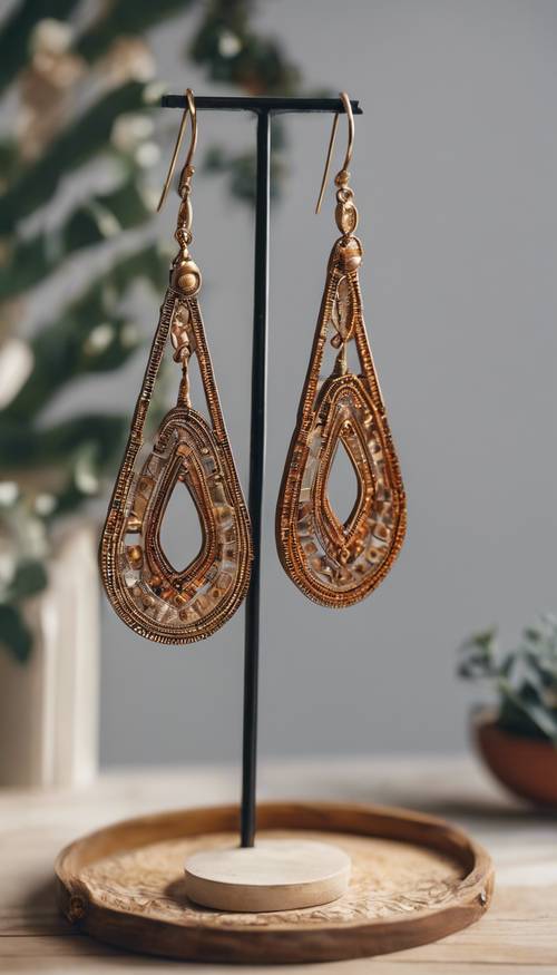 Boho geometric earrings hanging on a jewelry stand. Wallpaper [06b4a63a114547fd9a77]