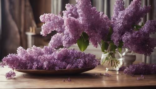 A brown antique wooden table with a vase of fresh purple lilacs. کاغذ دیواری [f6f2350038a04a0493b7]