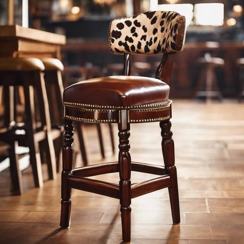 A Western-style bar stool with a cow print seat and a rich mahogany wood frame. 墙纸 [ac05e9b9eb8d4a2aa6b0]