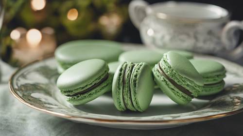A close-up of a sage green Macaron delicately arranged on fancy china.