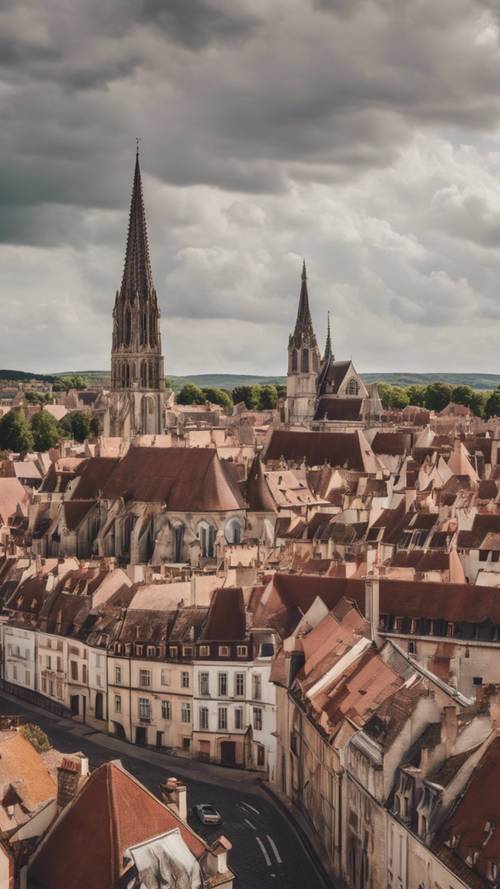 The skyline view of Burgundy City's terracotta rooftops, with the towering Gothic Burgundy Cathedral standing in stark contrast against the cloudy sky.