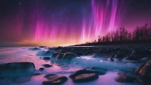 A beach at night, lit up by a vibrant display of Northern Lights reflecting on the calm sea surface.