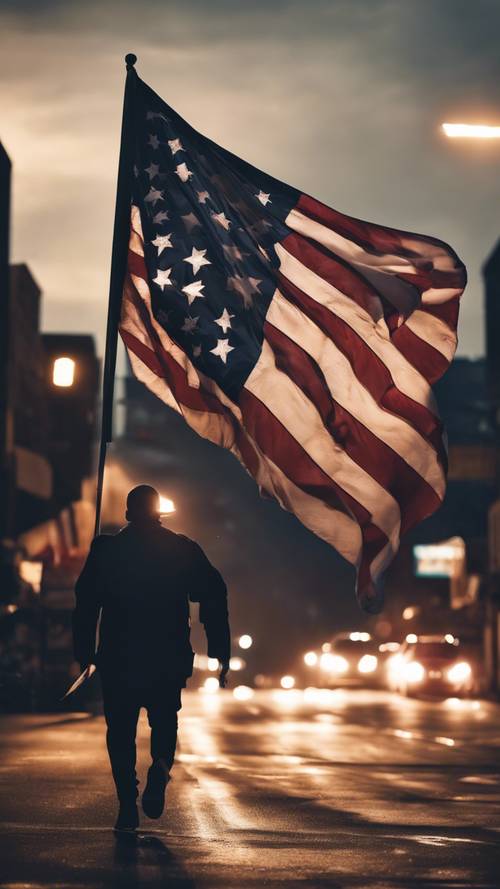 一面雄伟的黑色美国国旗在猛烈的夜风中飘扬。