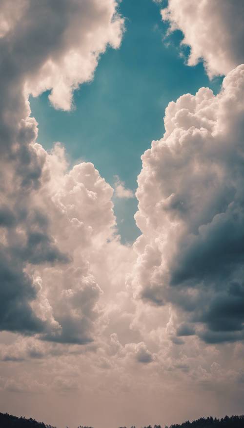 A black-and-white photo turned colorful with smoky pastel blue clouds. Tapet [f3f73d5ca76a4732a120]