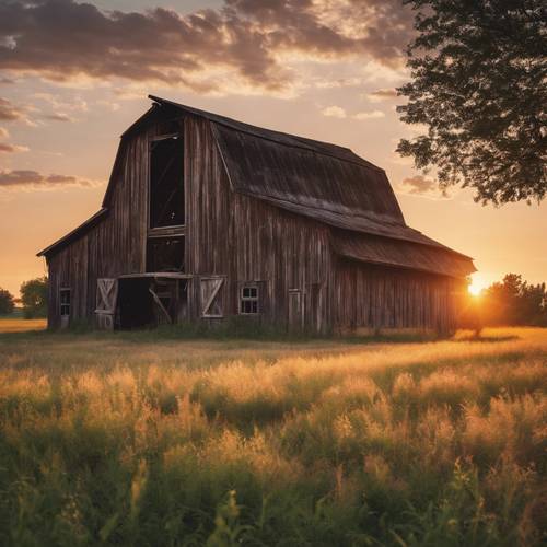 A majestic sunset over an old barn in a sprawling, Midwestern prairie.