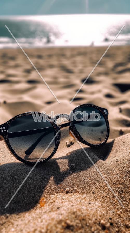 해변 모래 위의 선글라스