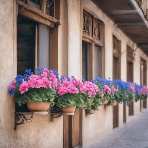 A quaint French balcony draped with pink geraniums and blue lobelia in hanging pots.