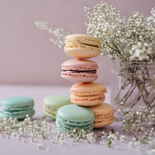 Previous pastel colors of macarons arranged with sprigs of baby's breath to create a chic floral aesthetic.