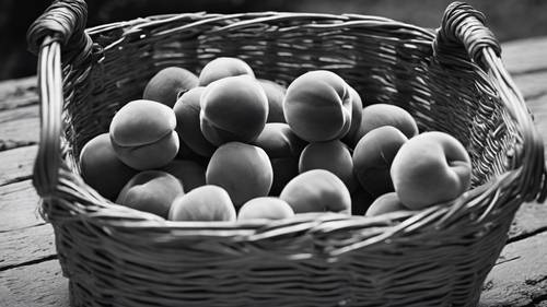 Monochrome photograph of peaches in a rustic basket.