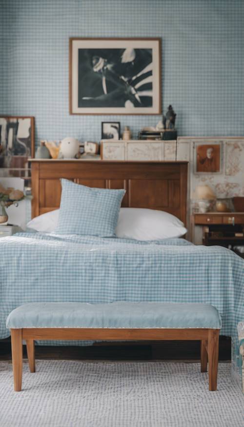 연한 파란색과 흰색의 깅엄 무늬 벽지와 빈티지 목재 가구로 꾸민 프레피 침실입니다.