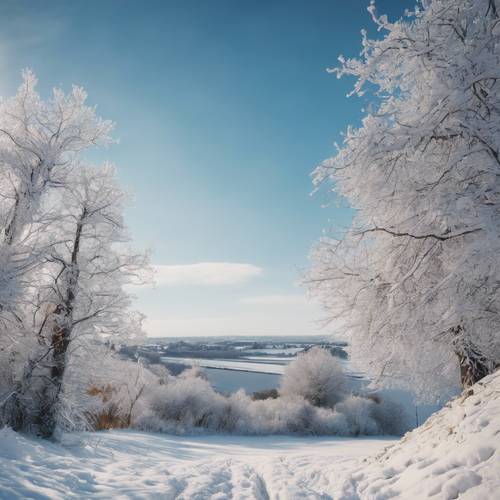 A peaceful countryside blanketed in fresh snow under a clear blue winter sky.