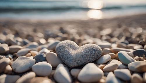 Un coeur fait de galets sur la plage.