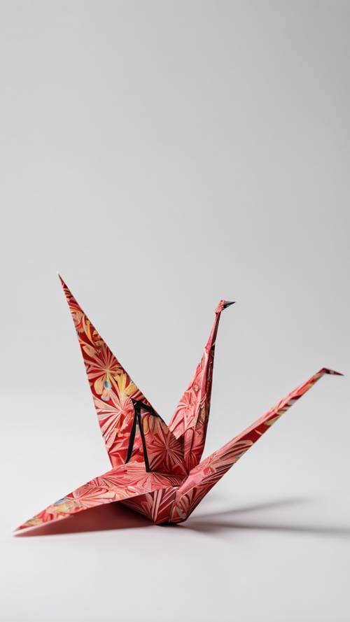 An origami crane made from a vibrant piece of patterned Japanese paper, set against a stark white background.