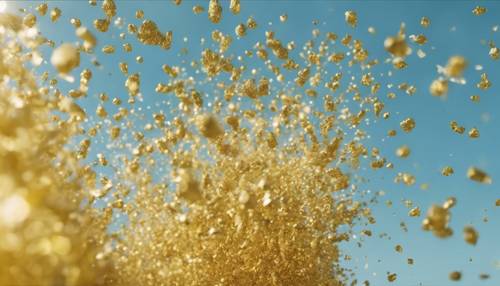 Yellow glitter being blown into the air in slow motion against a blue sky. Tapet [4628f91a9785488092e0]