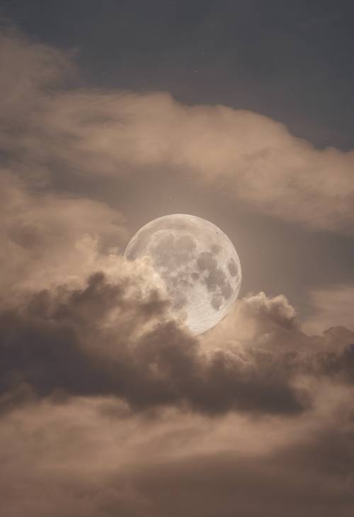 Wisps of beige stratus clouds veiling the full moon.