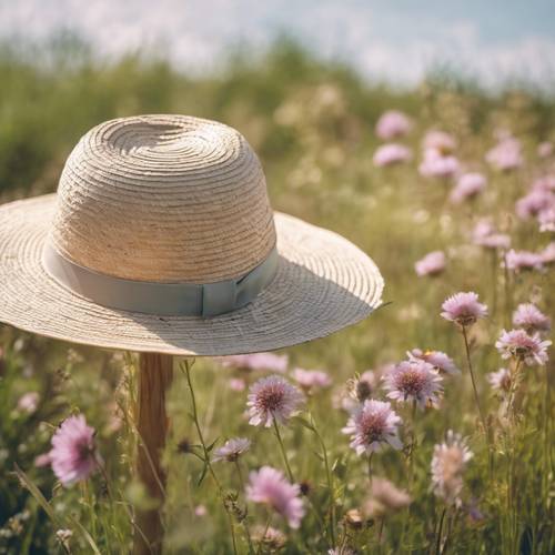 Pastel colored wildflowers crowning a straw hat.