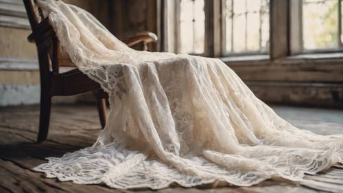 An antique white lace wedding gown draped over an old wooden chair.