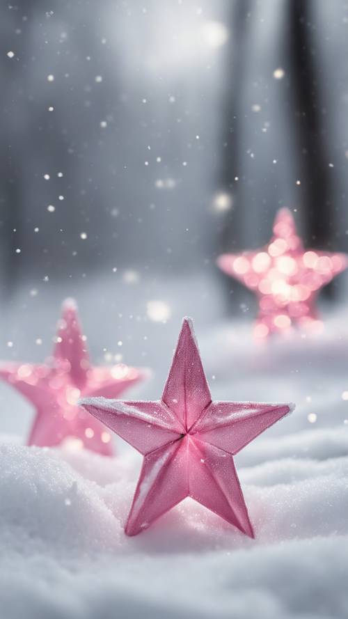 하얀 눈 덮인 풍경 위에 아름답게 배열된 세 개의 반짝이는 분홍색 별.