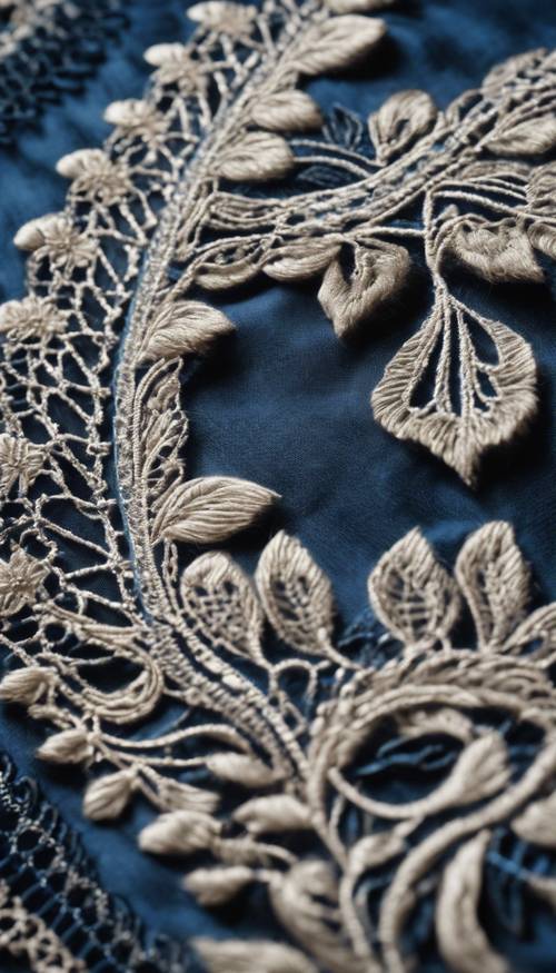 Close-up of dark blue lace fabric showing detailed embroidery