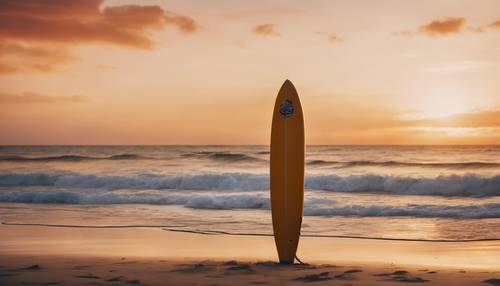 A lonely surfboard standing upright on deserted beach, against a stunningly vibrant sunset.
