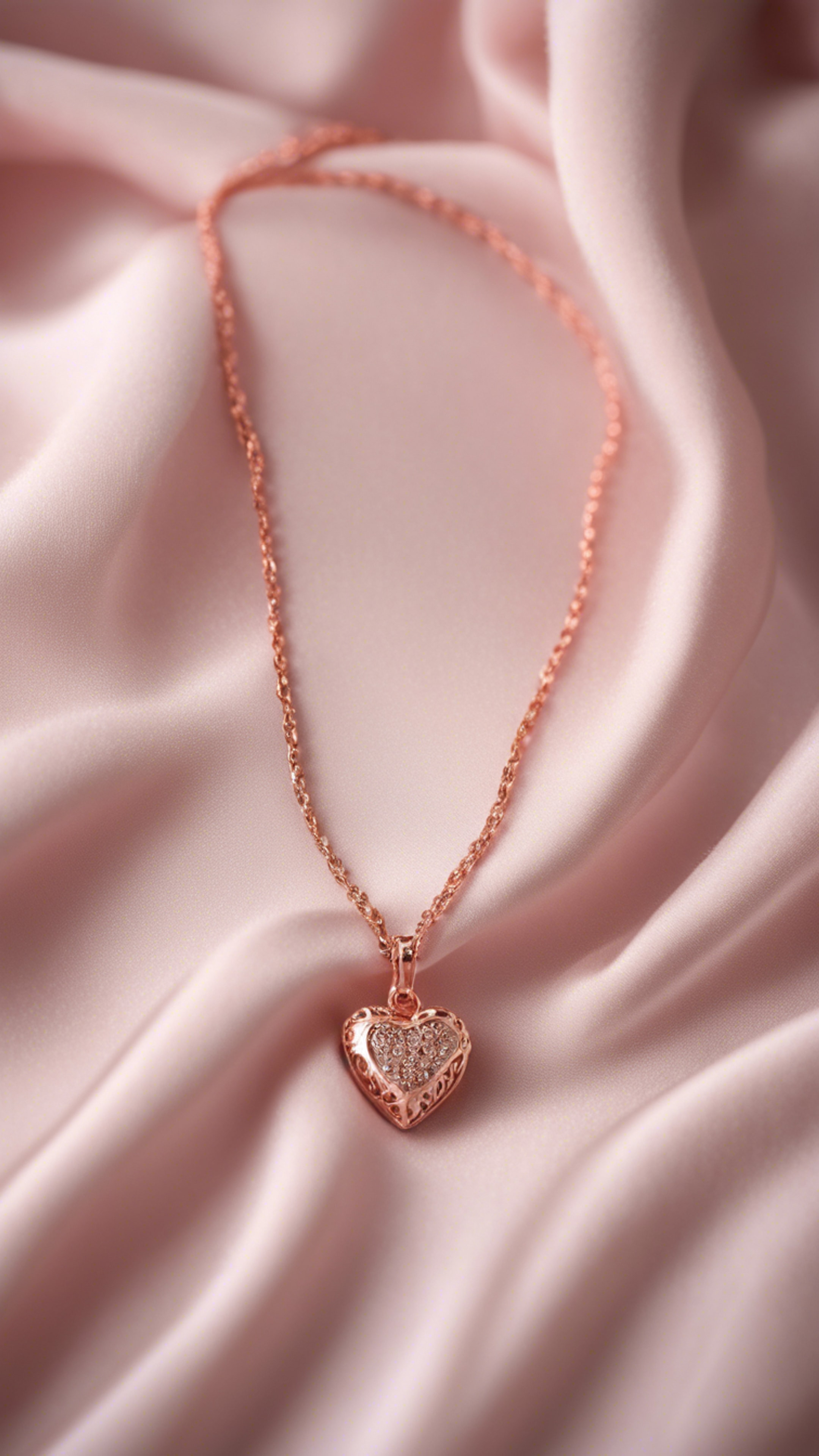 A delicate rose gold chain necklace with a small heart pendant, displayed on a soft pink satin fabric. ផ្ទាំង​រូបភាព[1bffd5f9a0f0499fae91]
