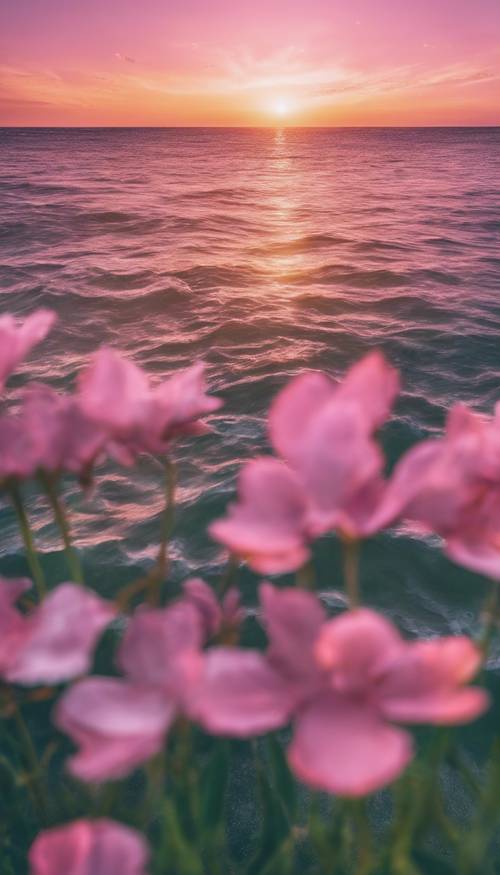 穏やかな海にピンクと緑色の夕日が沈む