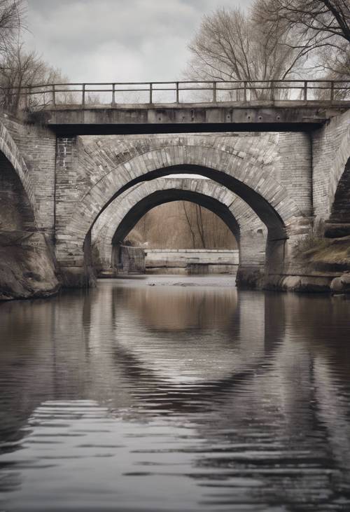 Une photo panoramique d&#39;un pont en briques grises et blanches traversant une rivière.