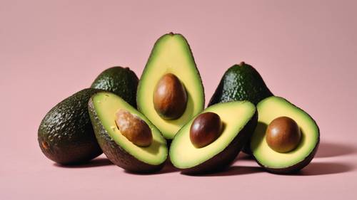 An artful arrangement of several avocados at different stages of ripeness against a pastel yellow background.
