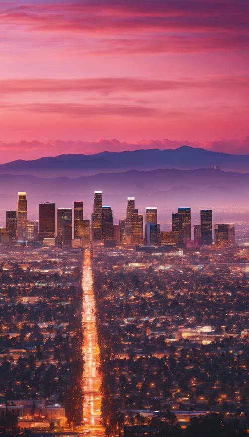 Pemandangan matahari terbenam yang menakjubkan di atas Los Angeles dengan rona warna jingga, merah muda, dan biru.