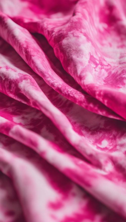 A close-up view of a vibrant pink tie-dye cotton T-shirt on a white background. Tapeta [2f110826d7d14b509742]