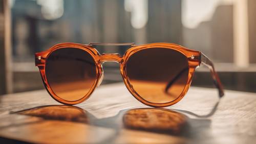 Orange and brown retro sunglasses on a glossy table.