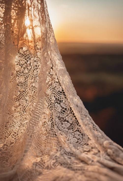 A cream lace pattern draping over a sunset landscape