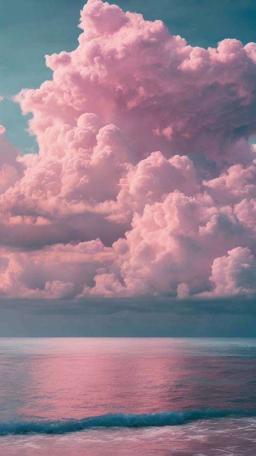 차가운 청록색 바다 위로 솟아오른 장엄한 분홍빛 구름