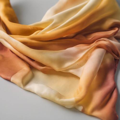 A silk scarf dyed with an ombre effect from bright marigold at one end to pale buttercream at the other. Tapetai [981e65485cc24ca08226]