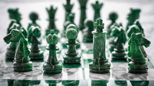 Green marble chess pieces on a white marble chessboard