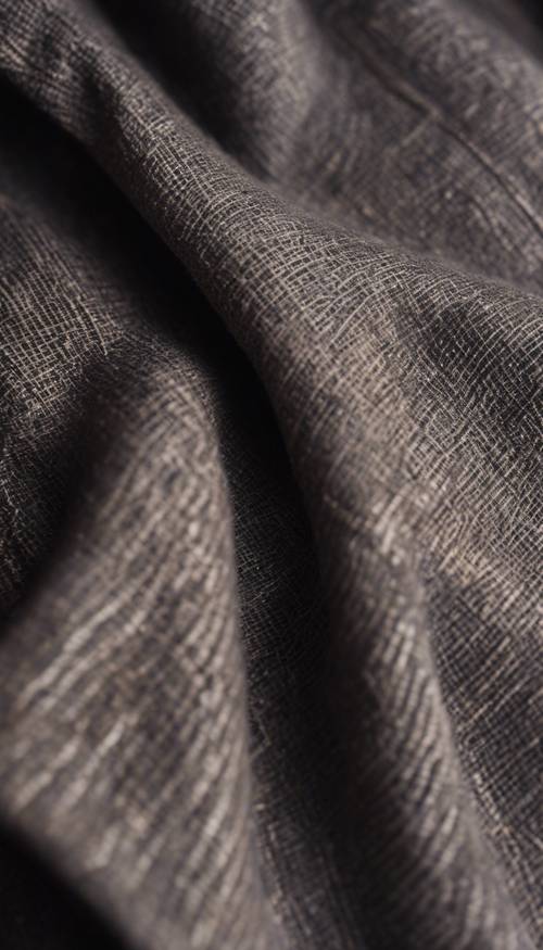 Patrón detallado de tela de lino oscuro con signos de desgaste y uso.