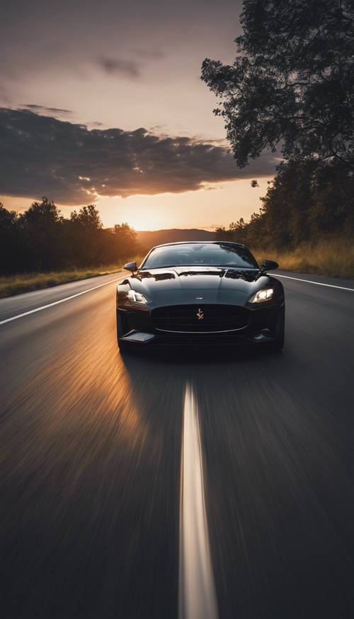 A sleek, black sports car speeding down an open road under a dusky evening sky. ផ្ទាំង​រូបភាព [128a2b28b78142cc855b]